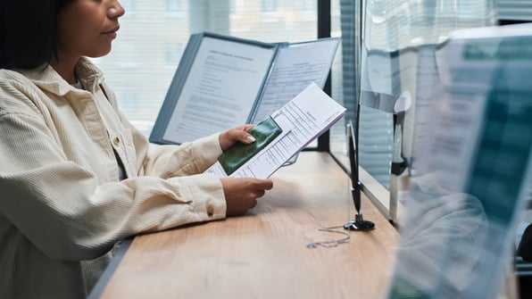 Government employee managing paper records they have to process. 